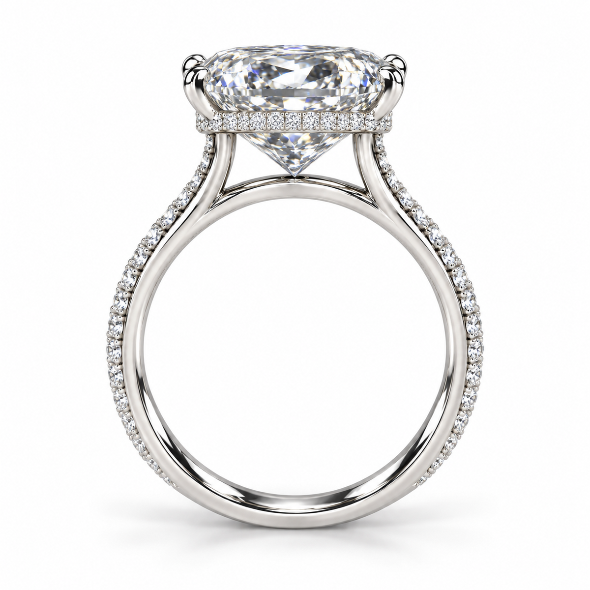 A radiant cut diamond engagement ring in a polished silver-colored metal setting, featuring a halo of small pavé diamonds along the band, shown on a clean white background.