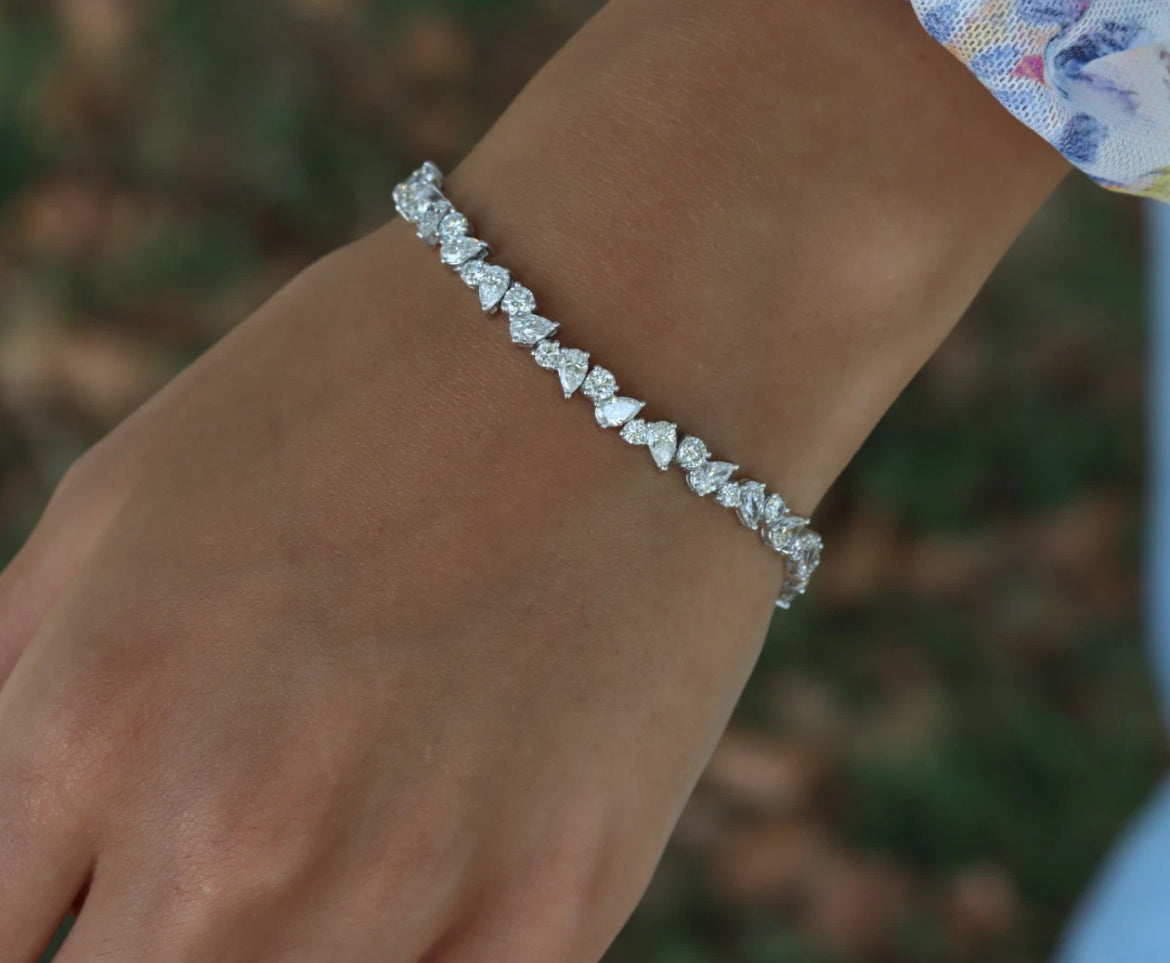 Diamond bracelet on a wrist with a blurred natural background