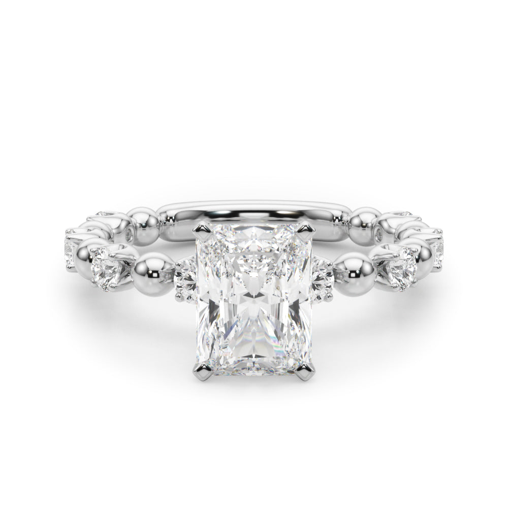 Diamond ring with a rectangular center stone on a white background