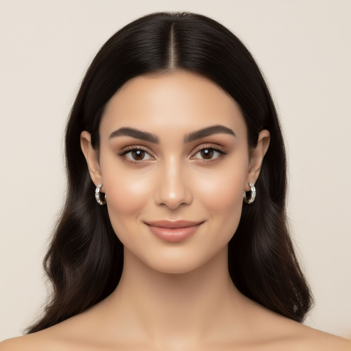 Front-facing model wearing white gold emerald-cut diamond hoop earrings