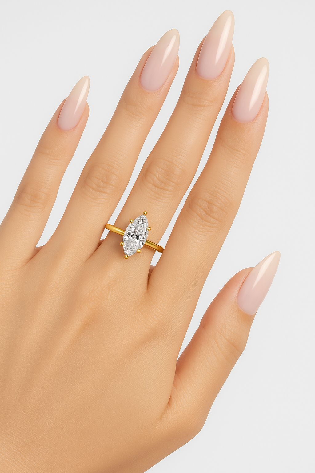 Marquise cut diamond engagement ring in 14K yellow gold shown on hand, featuring six-prong solitaire setting with 2.20 carat G VS IGI-certified diamond.
