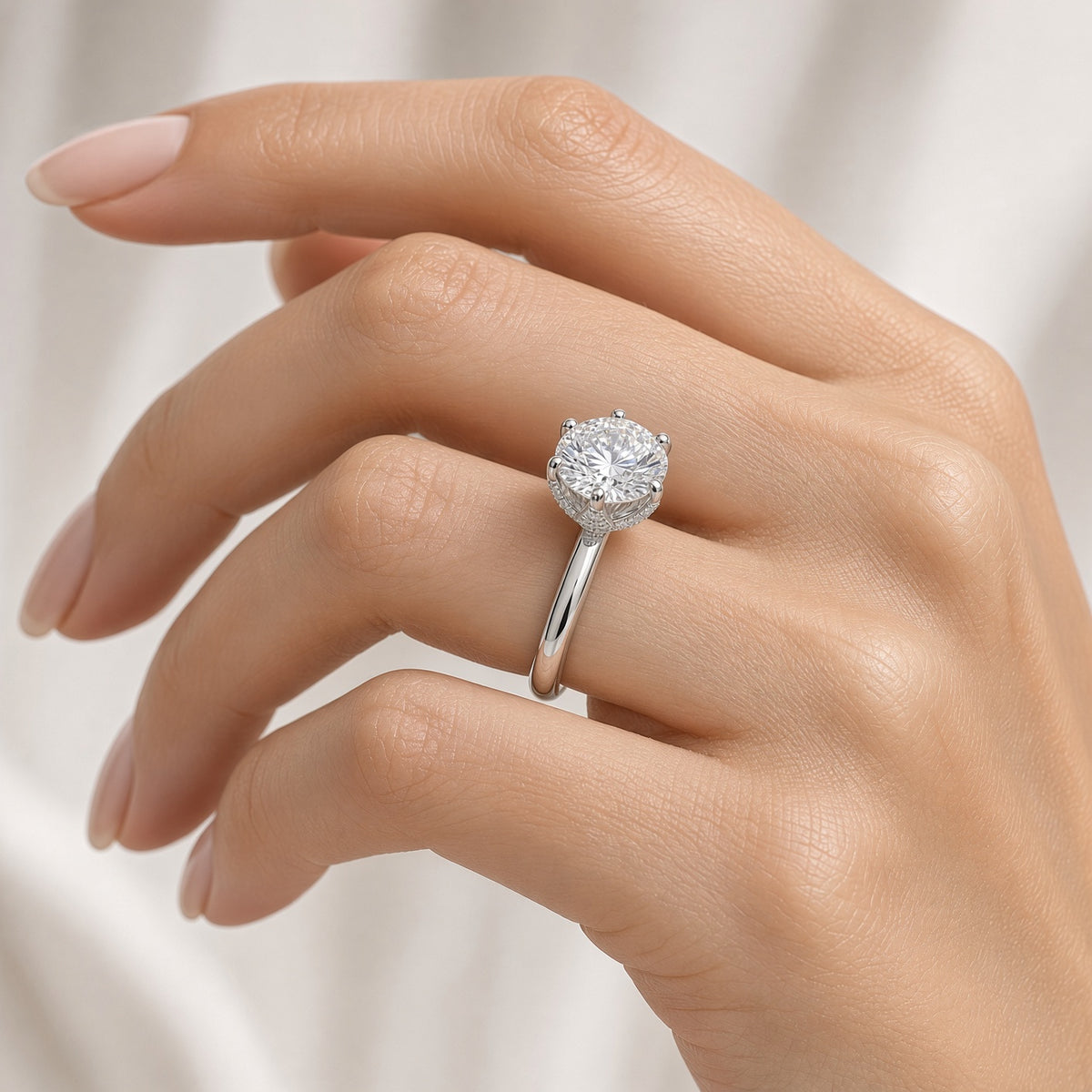 Round lab-grown diamond 6-prong engagement ring worn on hand