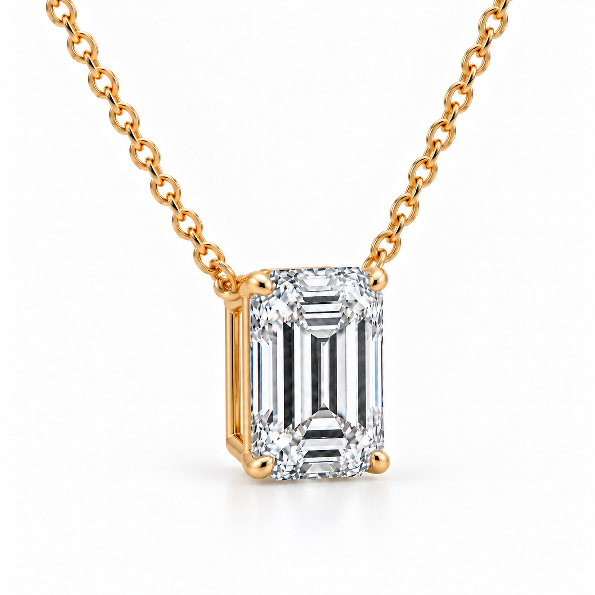 Angled view of emerald-cut lab-grown diamond pendant in 14K yellow gold