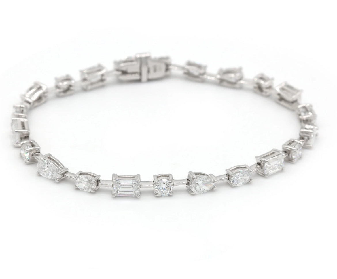 Diamond bracelet with rectangular and round stones on a white background