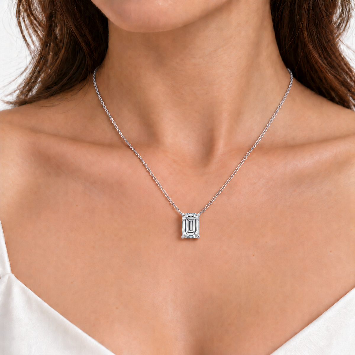 White gold emerald-cut diamond necklace worn on a model