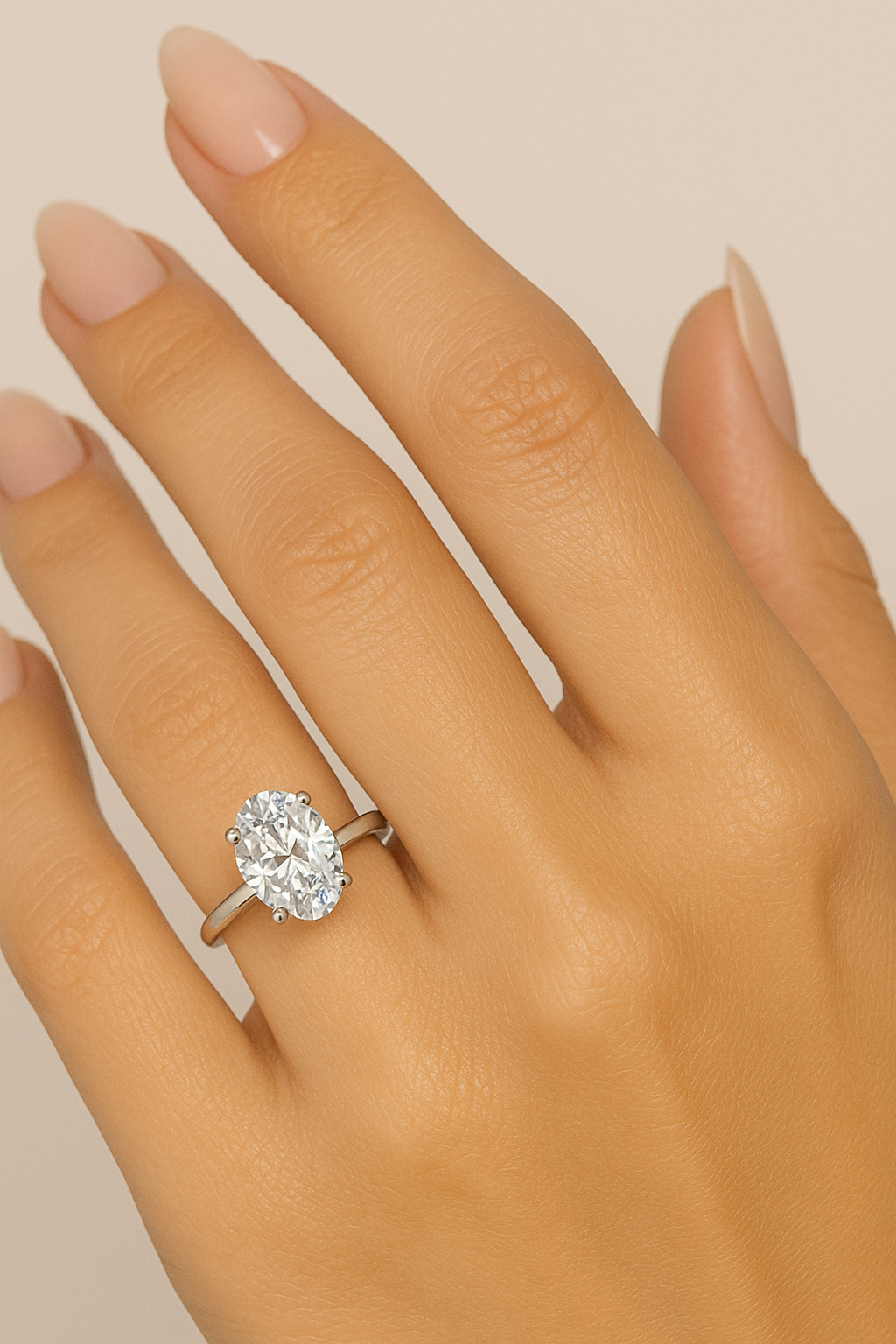 Oval-cut lab-grown diamond engagement ring in 14K gold shown on a hand against a neutral background, highlighting the sparkle and elegant solitaire design.
