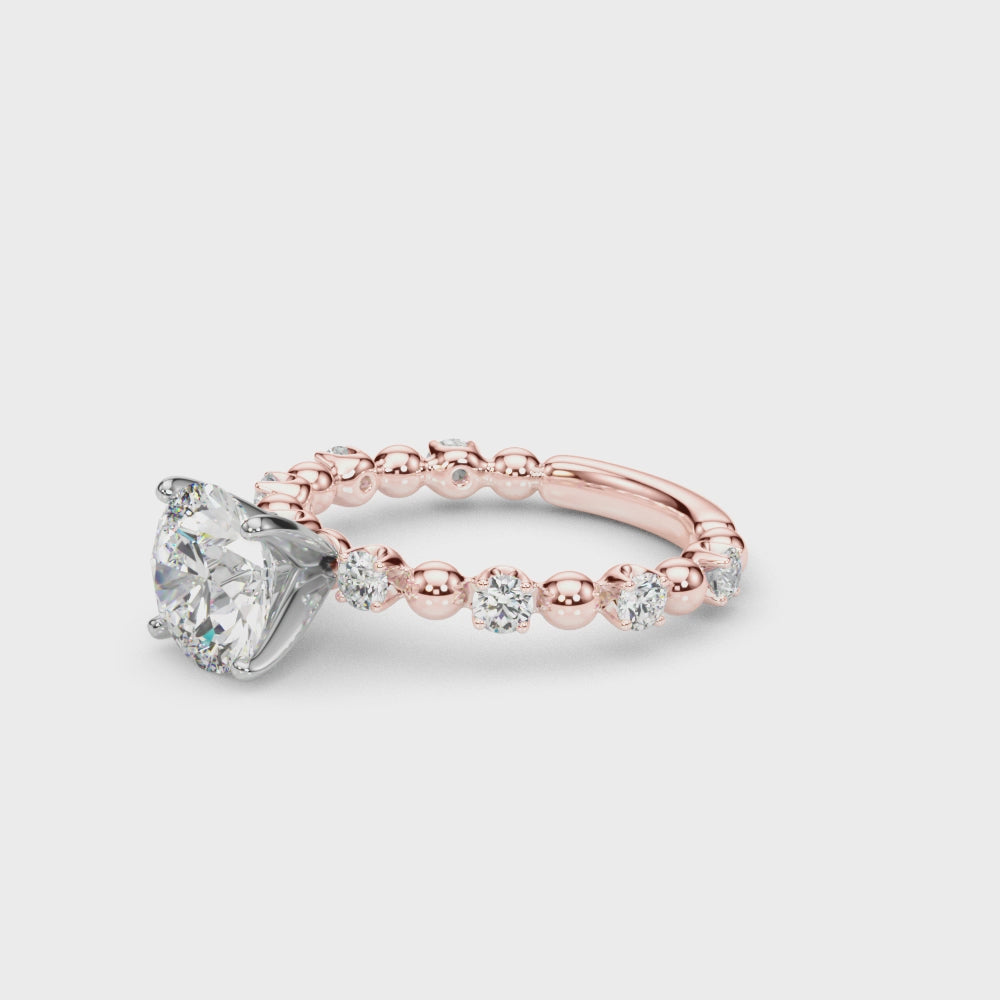 Video showcasing the round diamond engagement ring with a rose gold beaded band.