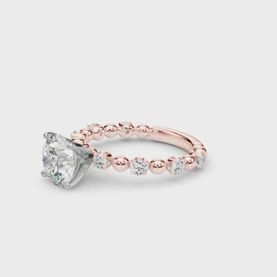 Video showcasing the round diamond engagement ring with a rose gold beaded band.