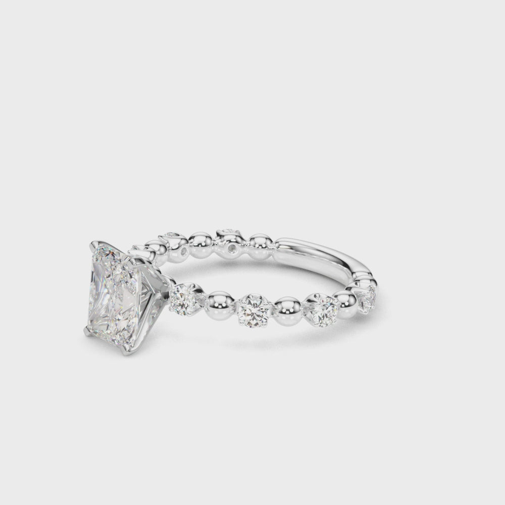 360° rotating view of a radiant cut lab diamond engagement ring in 14K white gold, featuring a 2.00 carat center stone with alternating round diamond and bead accents along the band, showcasing brilliance and craftsmanship from every angle