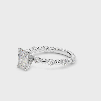 360° rotating view of a radiant cut lab diamond engagement ring in 14K white gold, featuring a 2.00 carat center stone with alternating round diamond and bead accents along the band, showcasing brilliance and craftsmanship from every angle