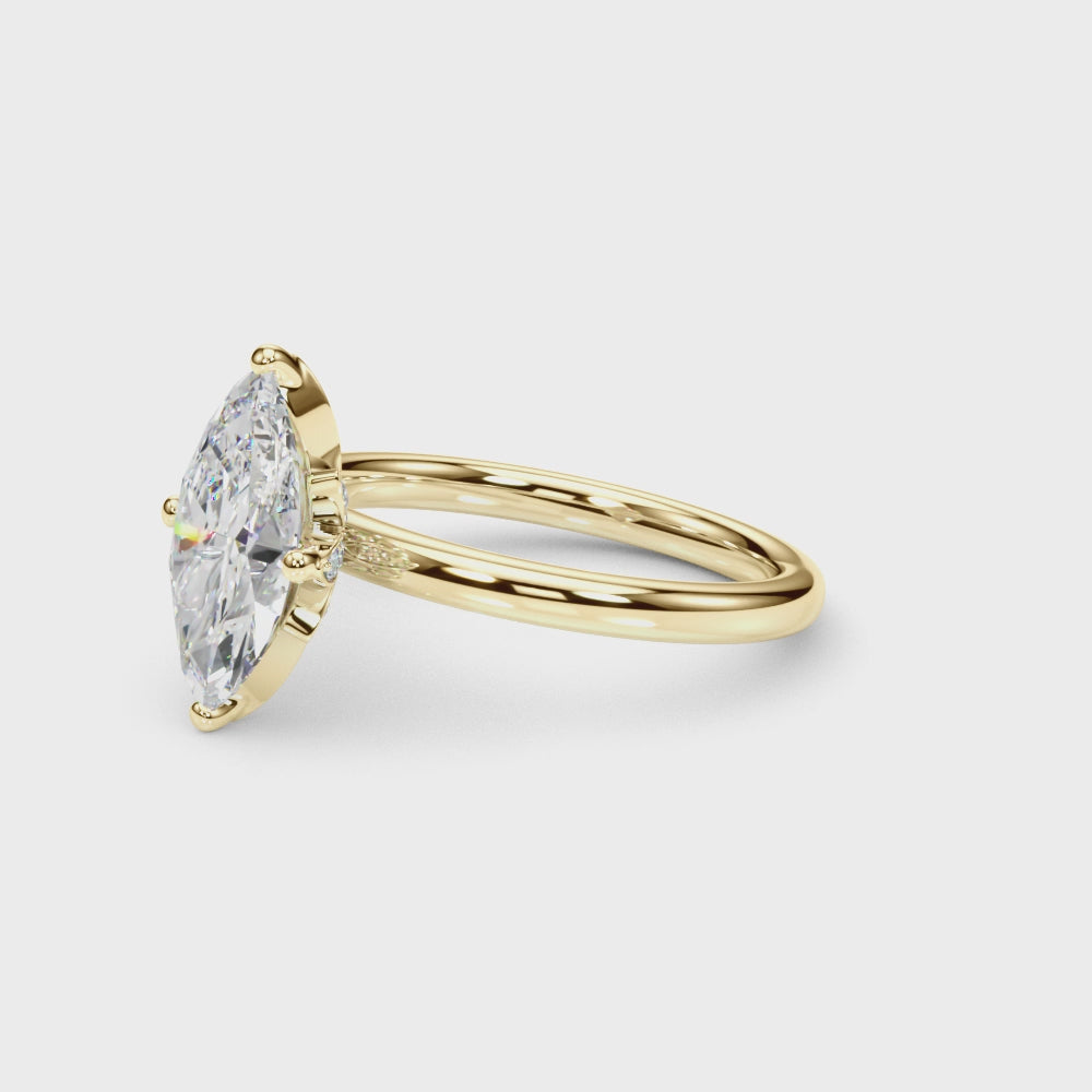 Rotating view of the yellow gold marquise engagement ring showing the pavé leaf gallery beneath the diamond.