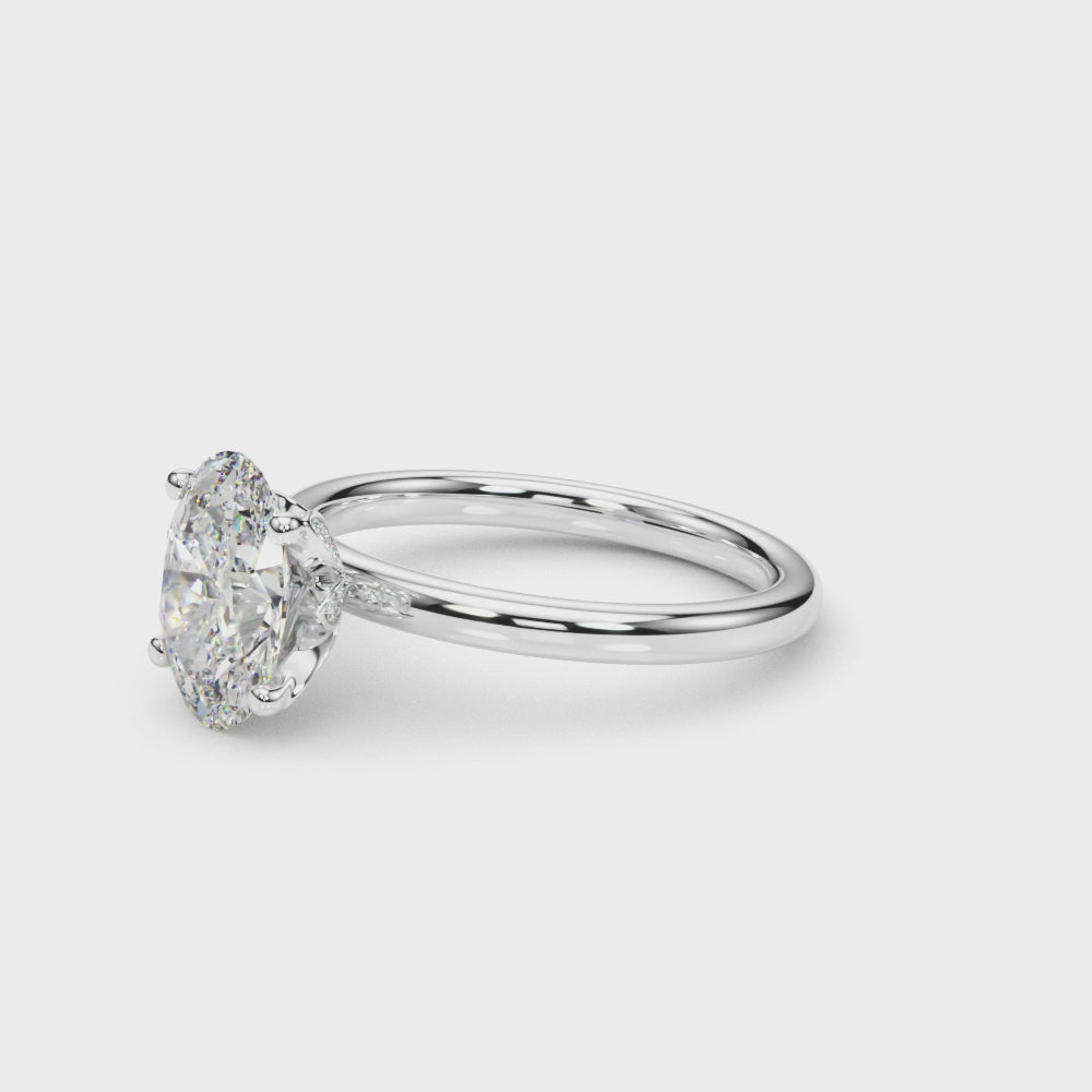 Rotating video of an oval-cut lab-grown diamond engagement ring in 14K white gold, featuring a hidden halo and sleek four-prong solitaire design that highlights its brilliance from every angle.