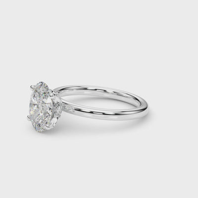 Rotating video of an oval-cut lab-grown diamond engagement ring in 14K white gold, featuring a hidden halo and sleek four-prong solitaire design that highlights its brilliance from every angle.