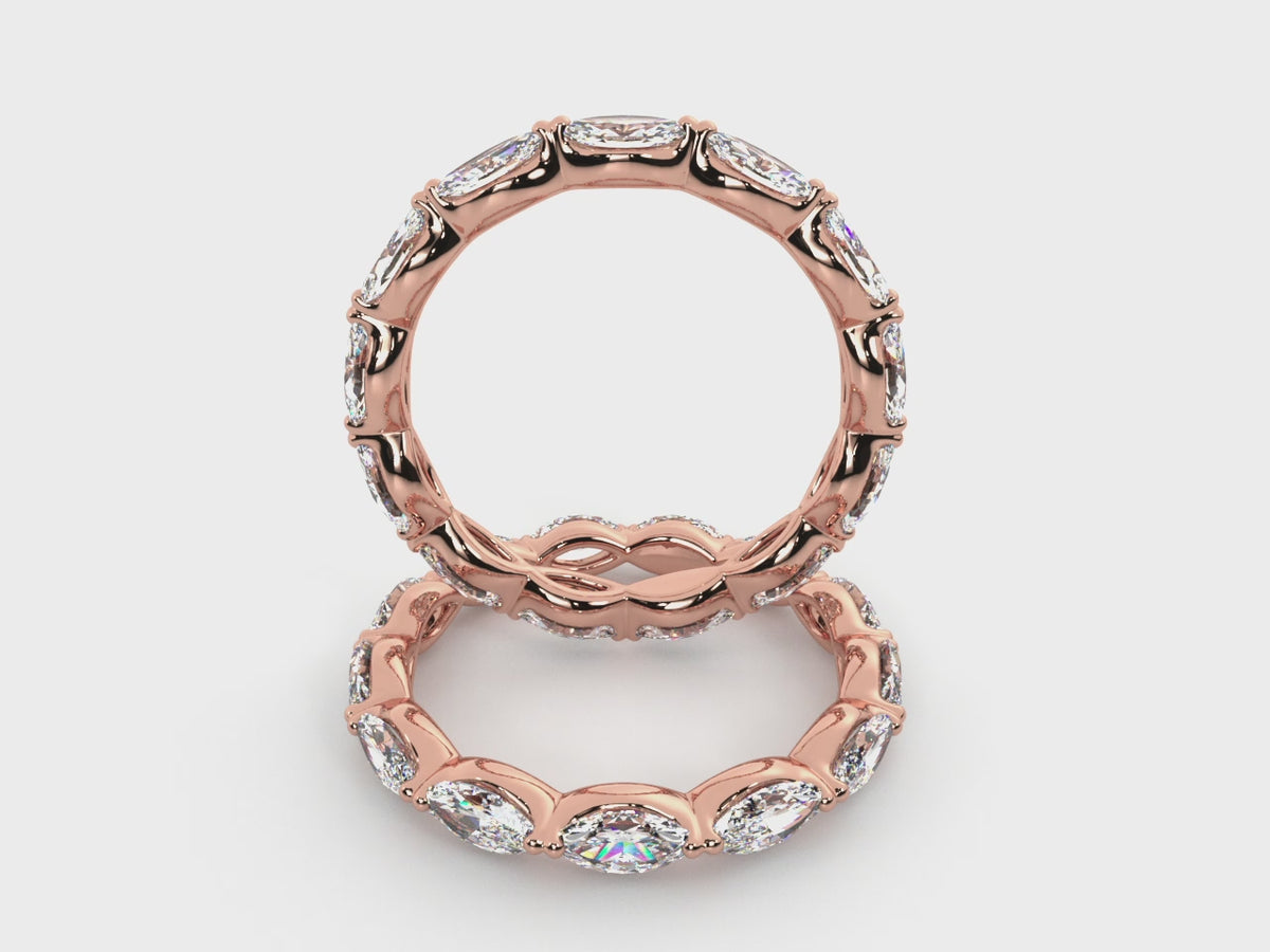 Rotating views of the 14K rose gold east-west marquise diamond eternity band.
