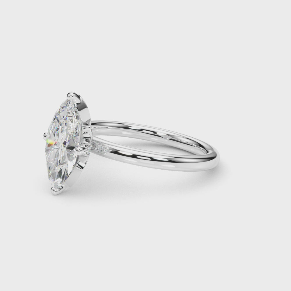 Rotating view of the white gold marquise diamond ring showing the pavé leaf gallery and polished band.