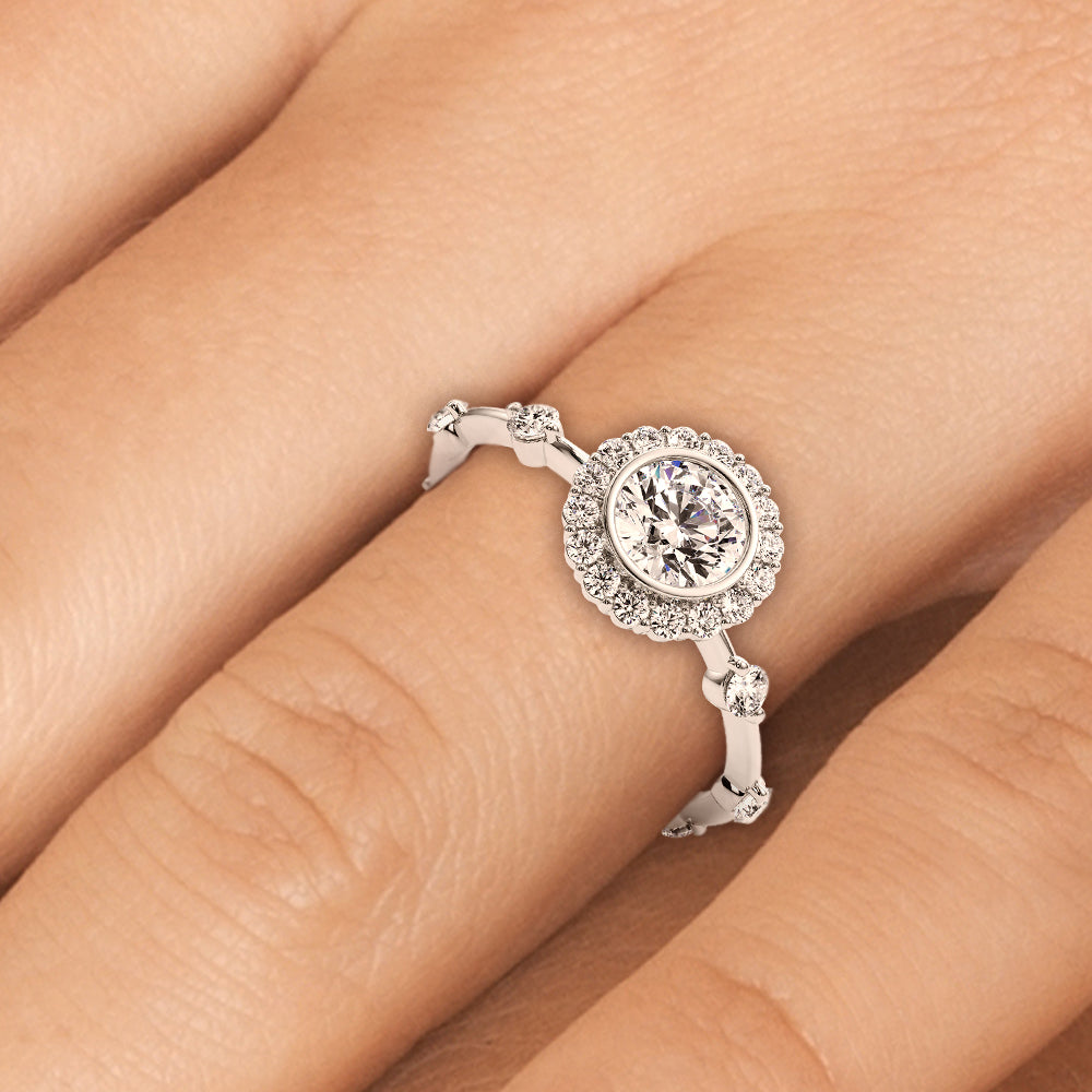 Bezel halo lab grown diamond engagement ring shown on hand for scale, sparkle, and band detailing.